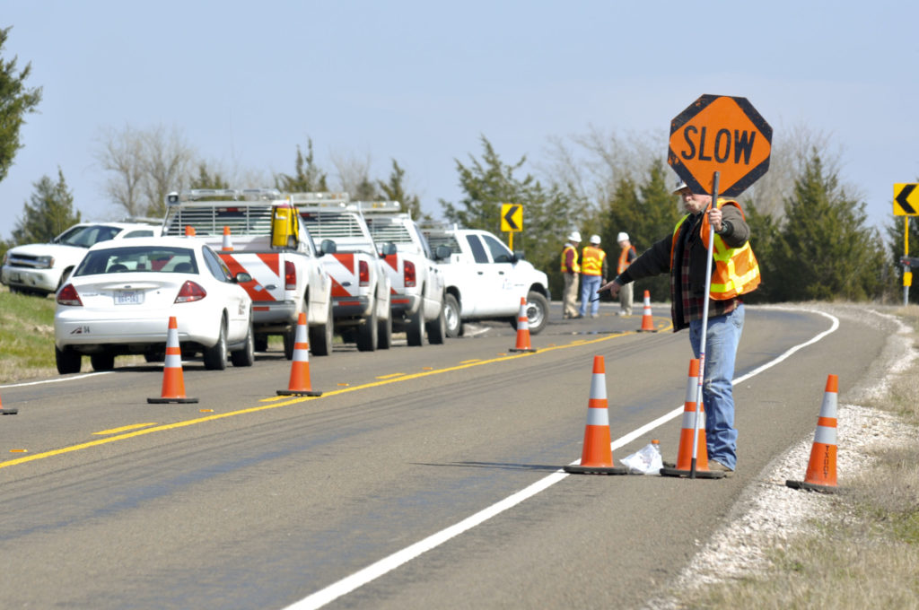 Worker Holding Slow Sign